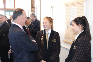 Prime Minister John Key with Baradene College Students and Shared Histories exhibition.